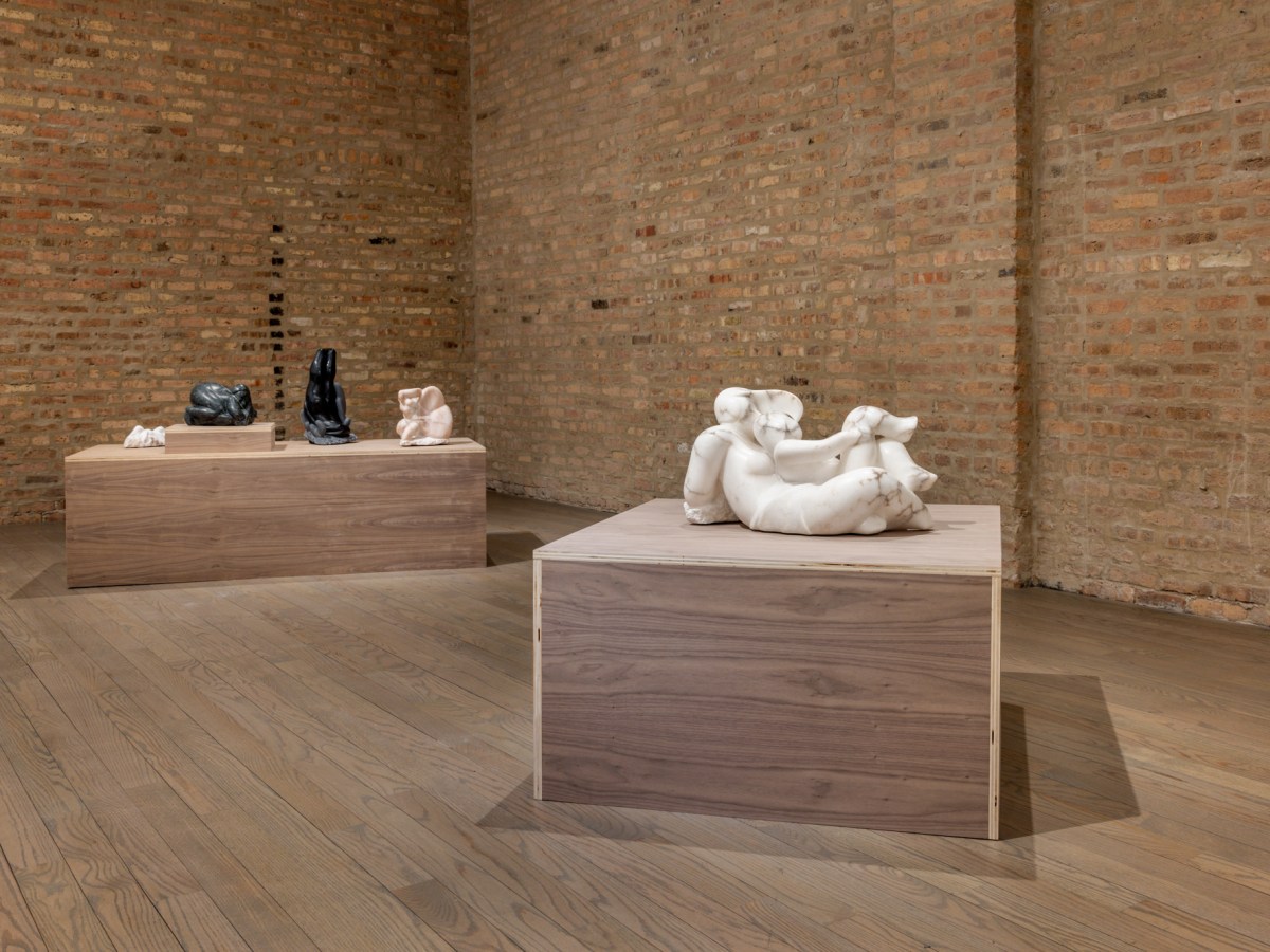 In the brick-walled gallery are two large wooden stands upon which sit a handful of hand carved stone sculptures.