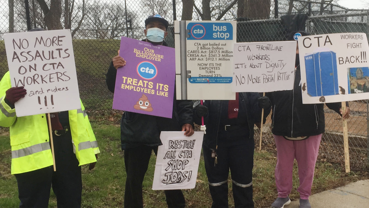 protesters stand in a line with signs promoting better working conditions for CTA
