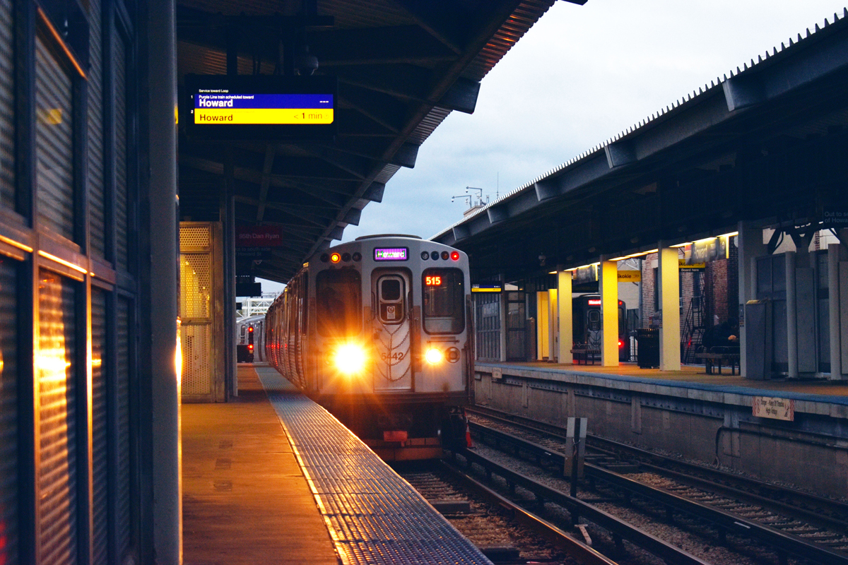 on a CTA platform, a train with golden lights on