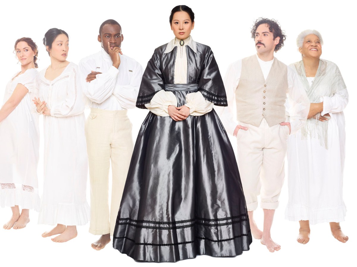 Six actors of various races and genders stand in a row against a white backdrop. Five of them are wearing light-colored clothing. Mi Kang, who plays protagonist Lucy Snowe, is dressed in a dark Victorian-like dress in the center.