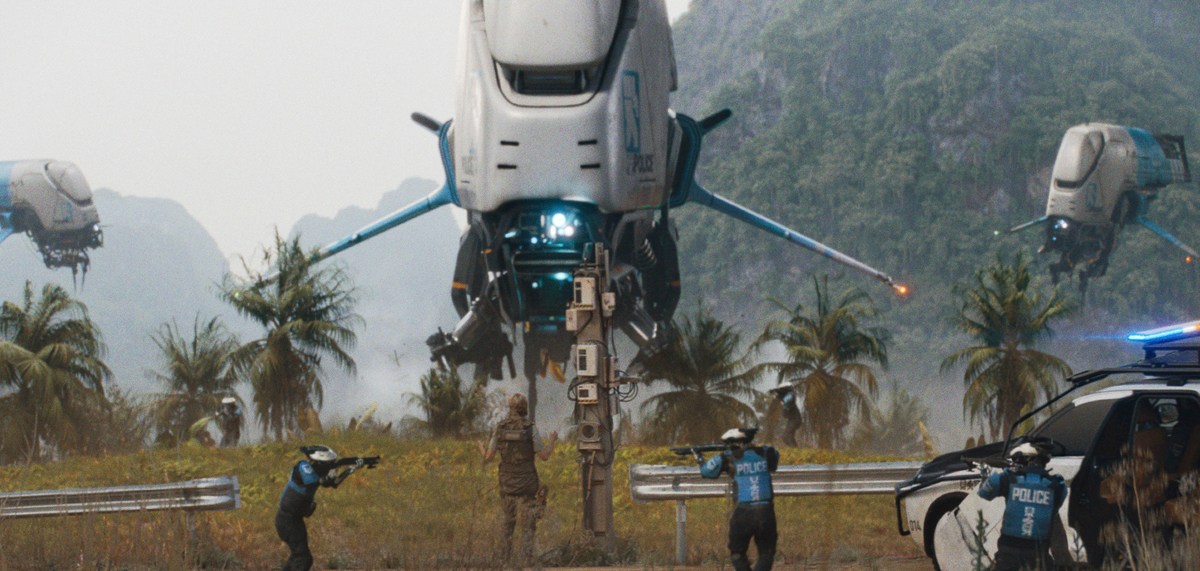 police shooters and helicopters surround a person against a lush, palm-treed landscape