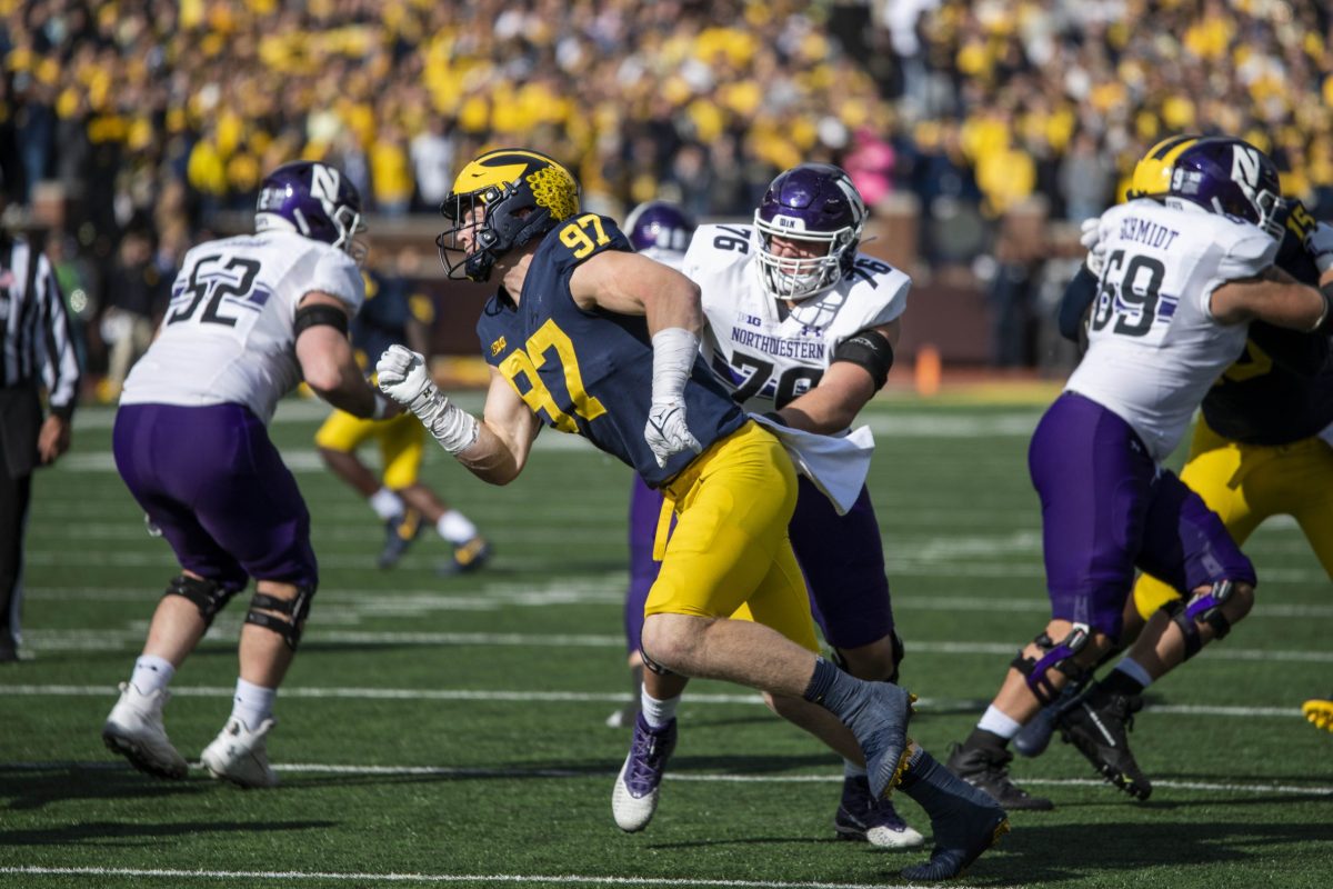 Northwestern university football players compete against university of michigan in a 2021 game
